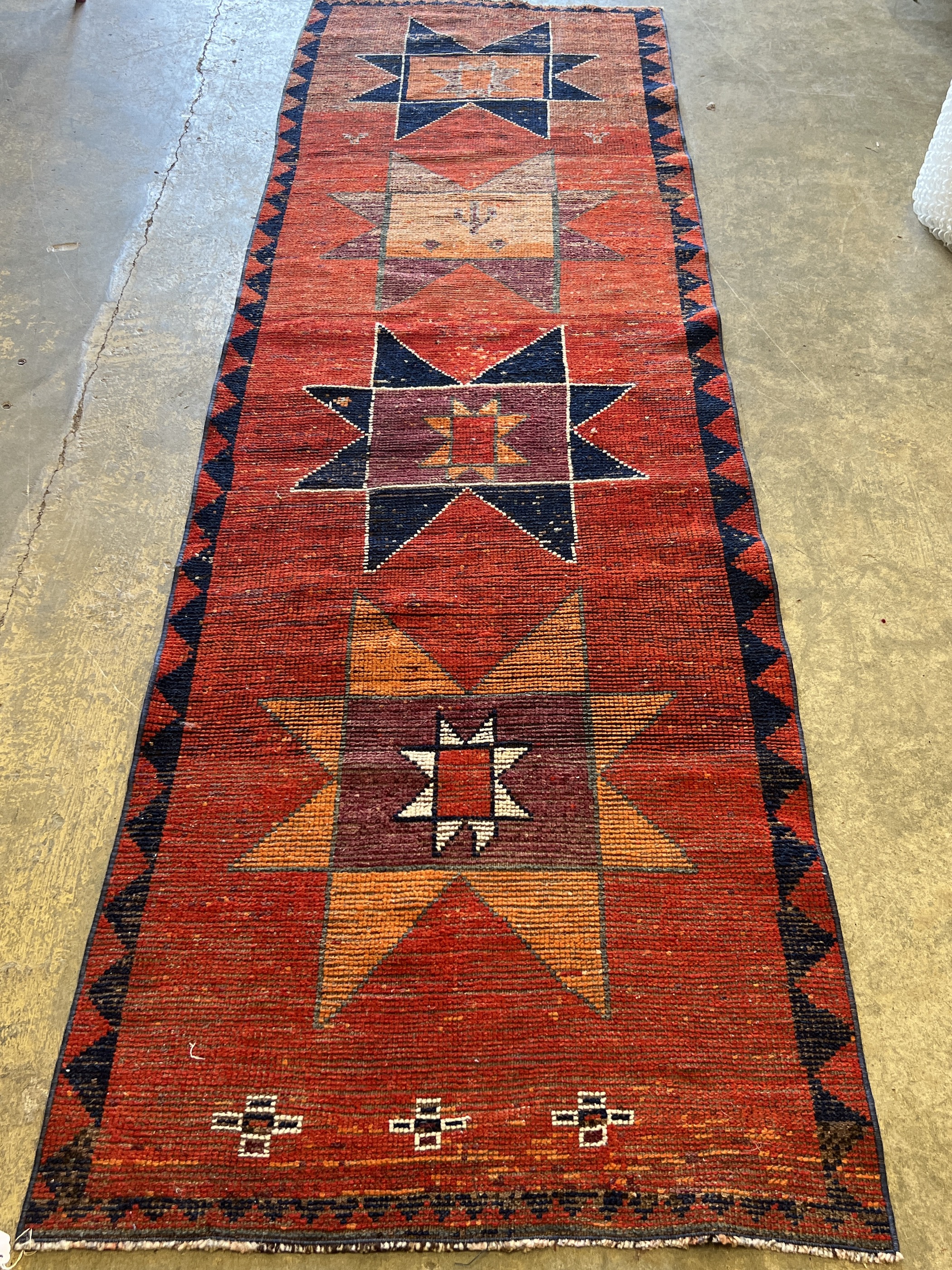 A Turkish red ground geometric runner, 298 x 87cm